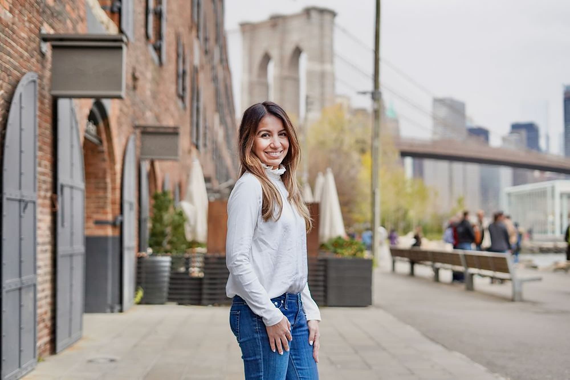 Dr. Lyssett Martínez in DUMBO, with the Brooklyn Bridge behind her